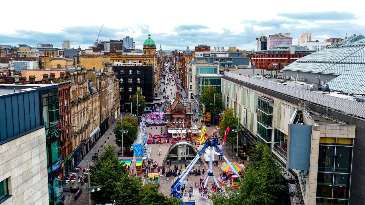 Buchanan Street and St. Enoch Square in Glasgow filled with colorful attractions, street activities, and pedestrians
